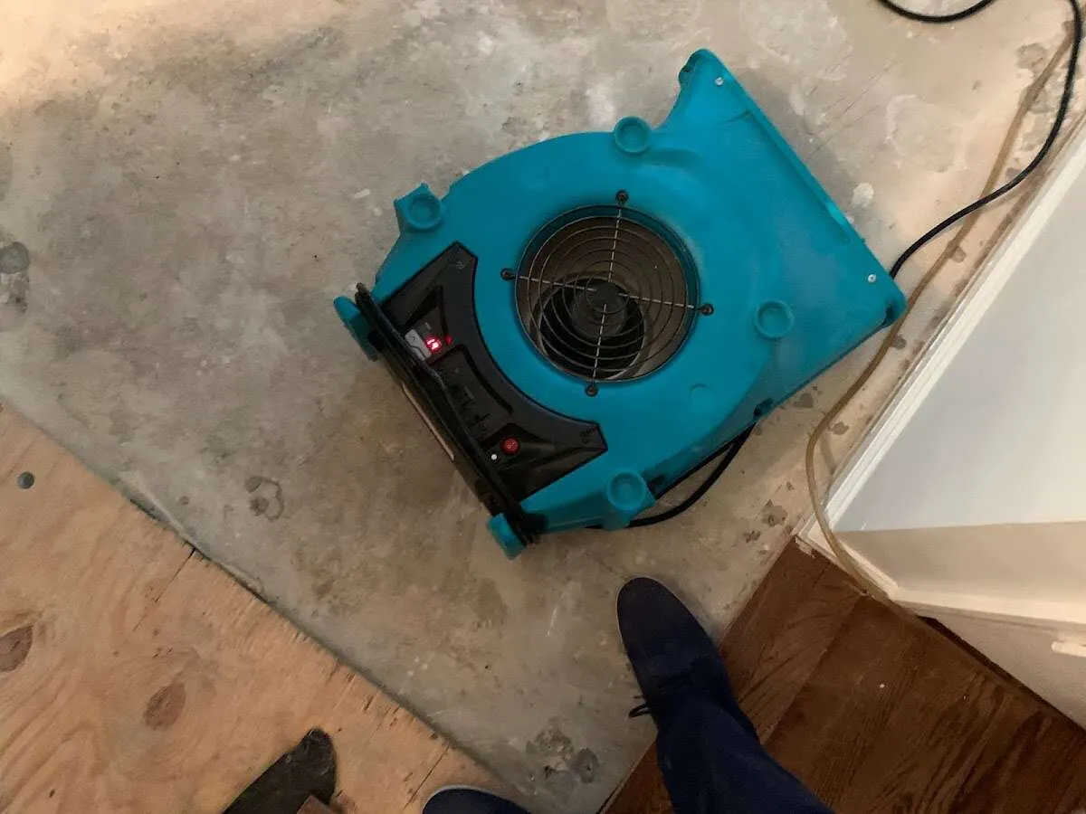 Air mover drying subfloor during Commercial Water Damage Restoration in Hialeah